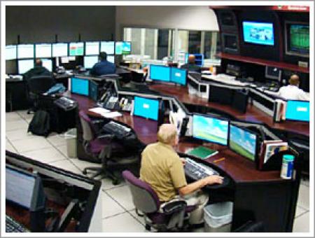 IT technicians sitting at their desks while working on computers